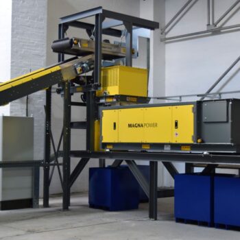 Eddy current separator extracting non-ferrous metals from eddy current waste stream with advanced magnetic separator setup for recycling and material recovery.