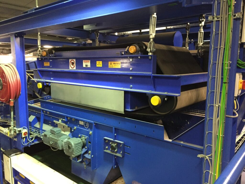 Overband magnetic separator removing ferrous metals from waste stream in a recycling and magnetic separation system. data-large-image=