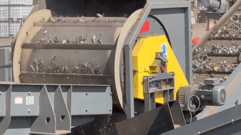 A heavy‑duty Frag Drum magnetic separator used in recycling to continuously remove ferrous metals from mixed waste, powered by a permanent magnet system. data-large-image=