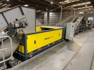 Eddy current separator extracting non-ferrous metals from eddy current waste stream with advanced magnetic separator setup for recycling and material recovery.