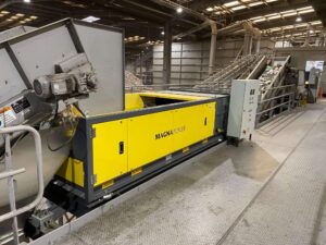 Eddy current separator extracting non-ferrous metals from eddy current waste stream with advanced magnetic separator setup for recycling and material recovery.