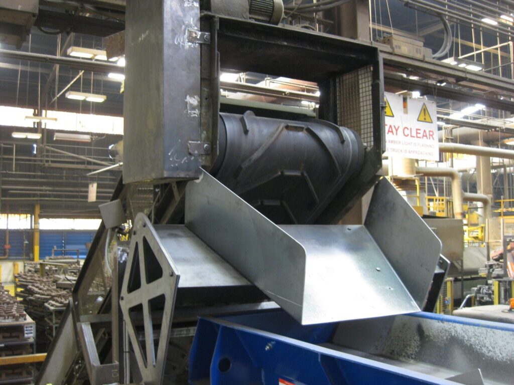 Image of a Magnapower magnetic head pulley installed at the end of a conveyor belt, designed for separating ferrous metals from bulk materials. data-large-image=