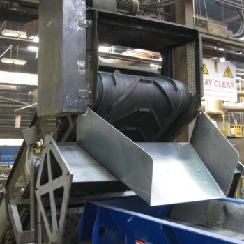 Image of a Magnapower magnetic head pulley installed at the end of a conveyor belt, designed for separating ferrous metals from bulk materials.