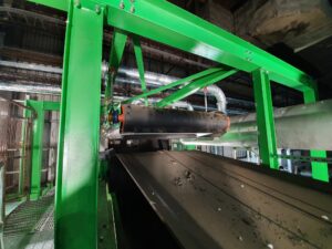 Overband magnetic separator removing ferrous metals from waste stream in a recycling and magnetic separation system.