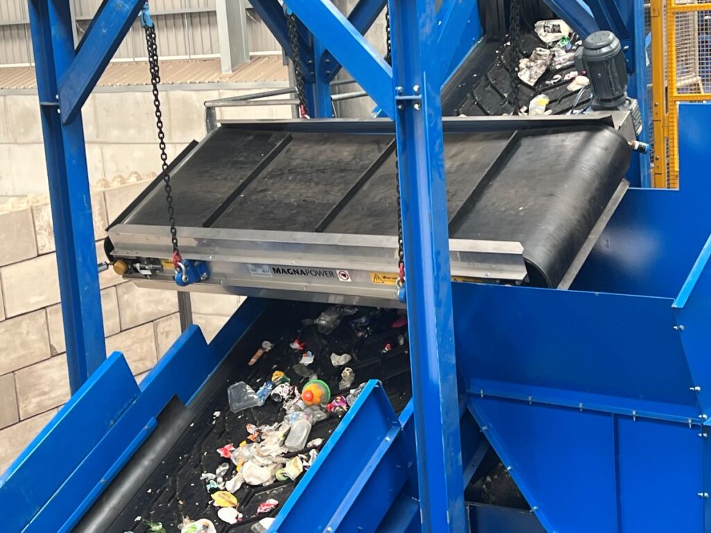 Overband magnetic separator removing ferrous metals from waste stream in a recycling and magnetic separation system. data-large-image=