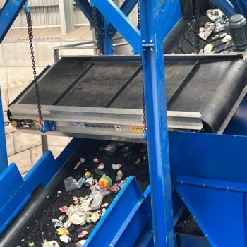 Overband magnetic separator removing ferrous metals from waste stream in a recycling and magnetic separation system.