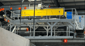 Eddy current separator extracting non-ferrous metals from eddy current waste stream with advanced magnetic separator setup for recycling and material recovery.