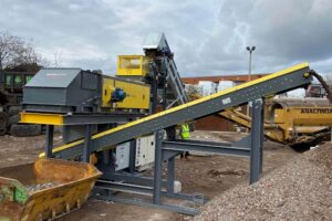 An on‑site installation featuring a drum magnet feeding an eddy current separator, with a discharge conveyor underneath collecting separated non‑ferrous metals.
