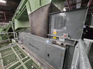 Eddy current separator extracting non-ferrous metals from eddy current waste stream with advanced magnetic separator setup for recycling and material recovery.